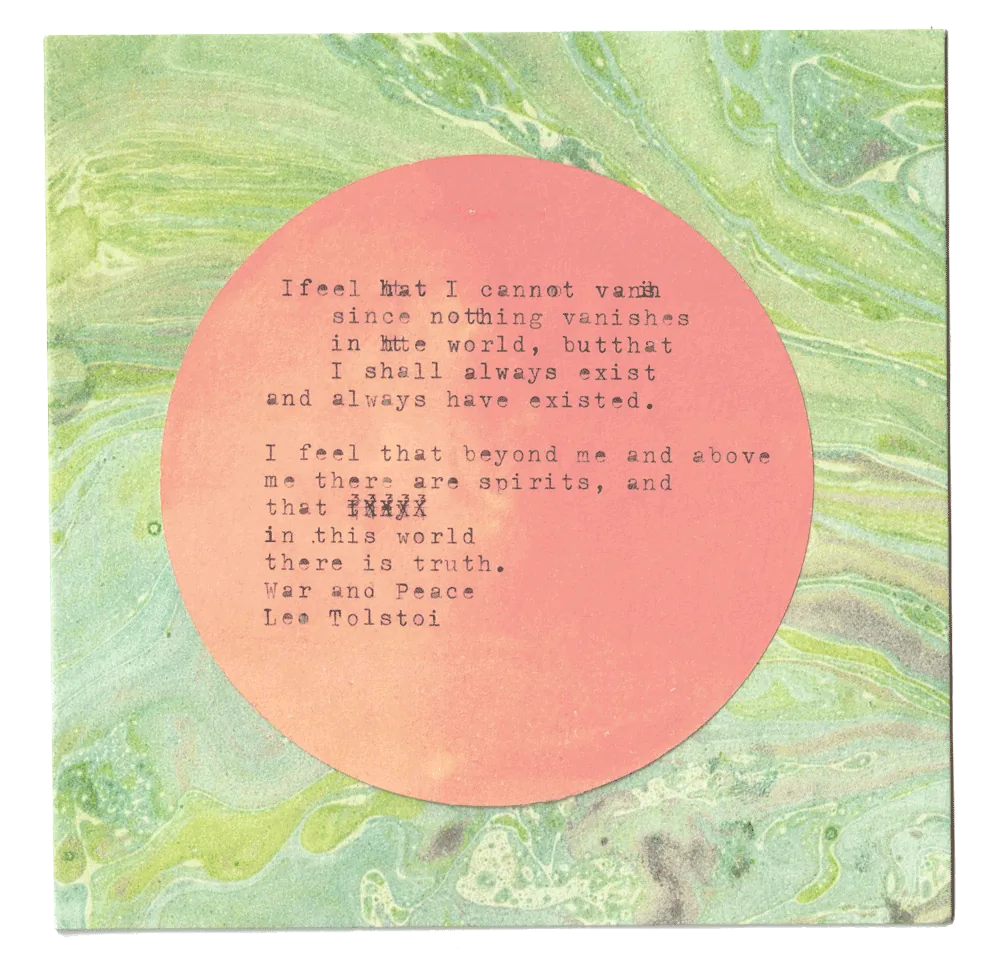 A marbled card with a typewritten Tolstoy passage